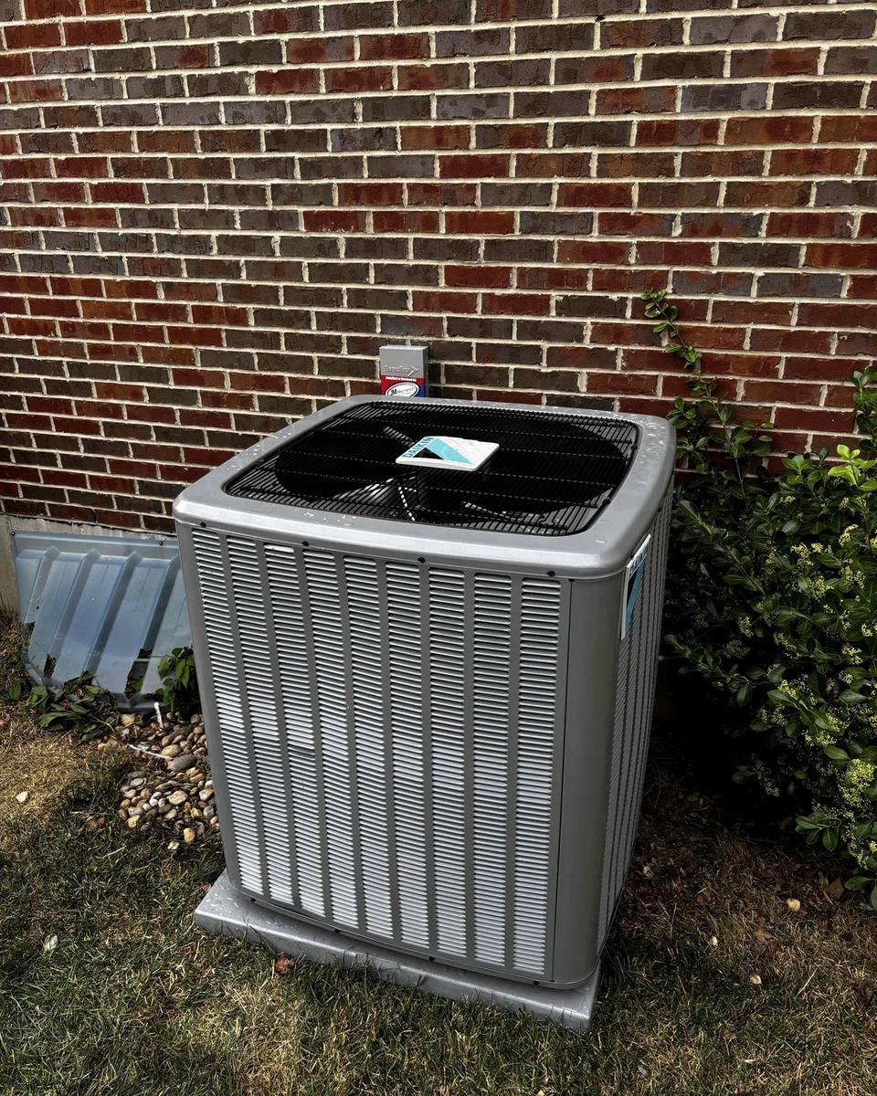 New condenser set against a brick home